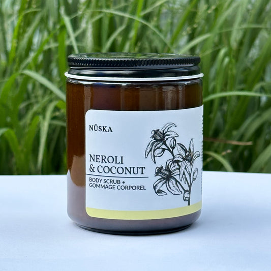 Jar of Nuska Neroli & Coconut Body Scrub with a green natural background