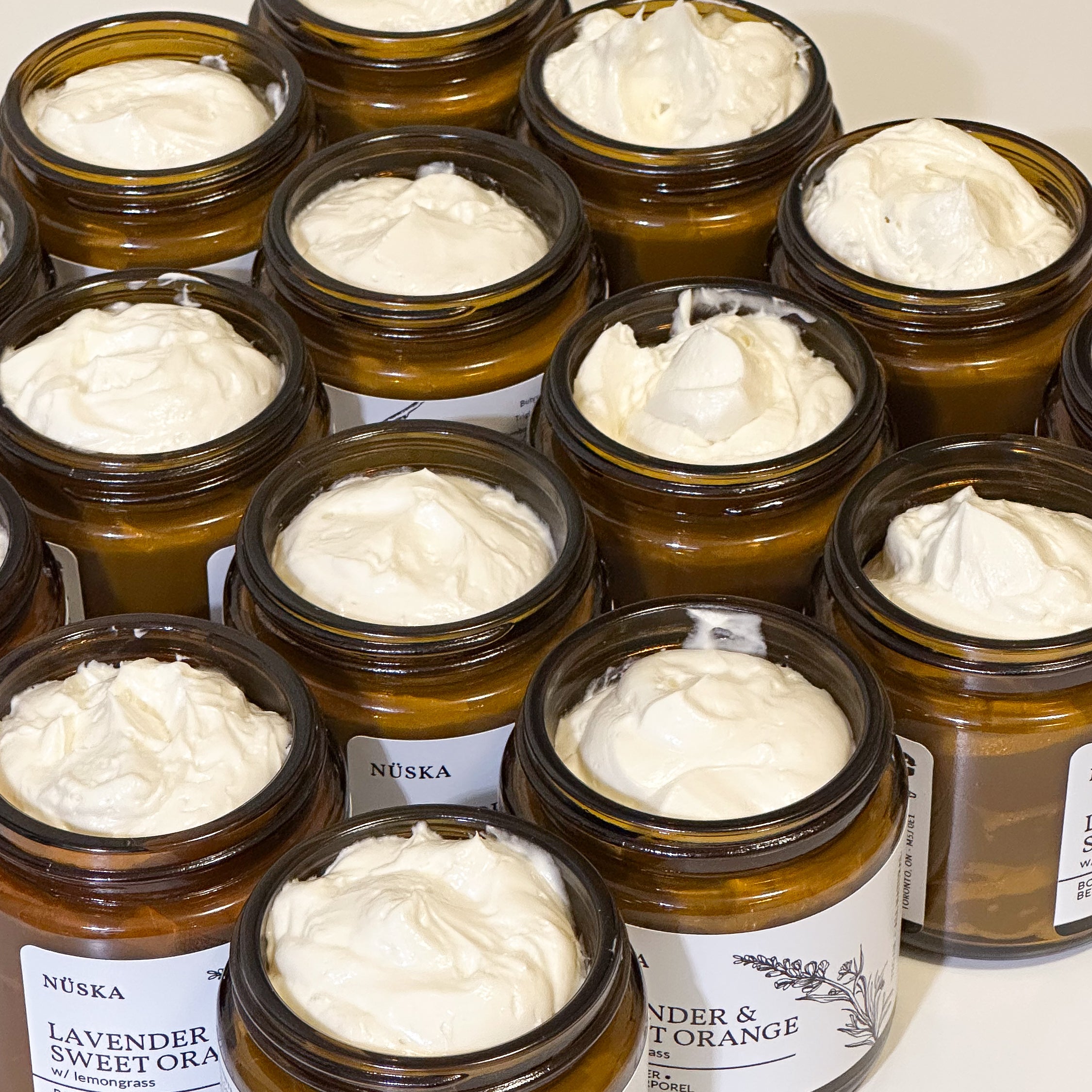nuska.ca body butter opened jars, showing the texture of the butter