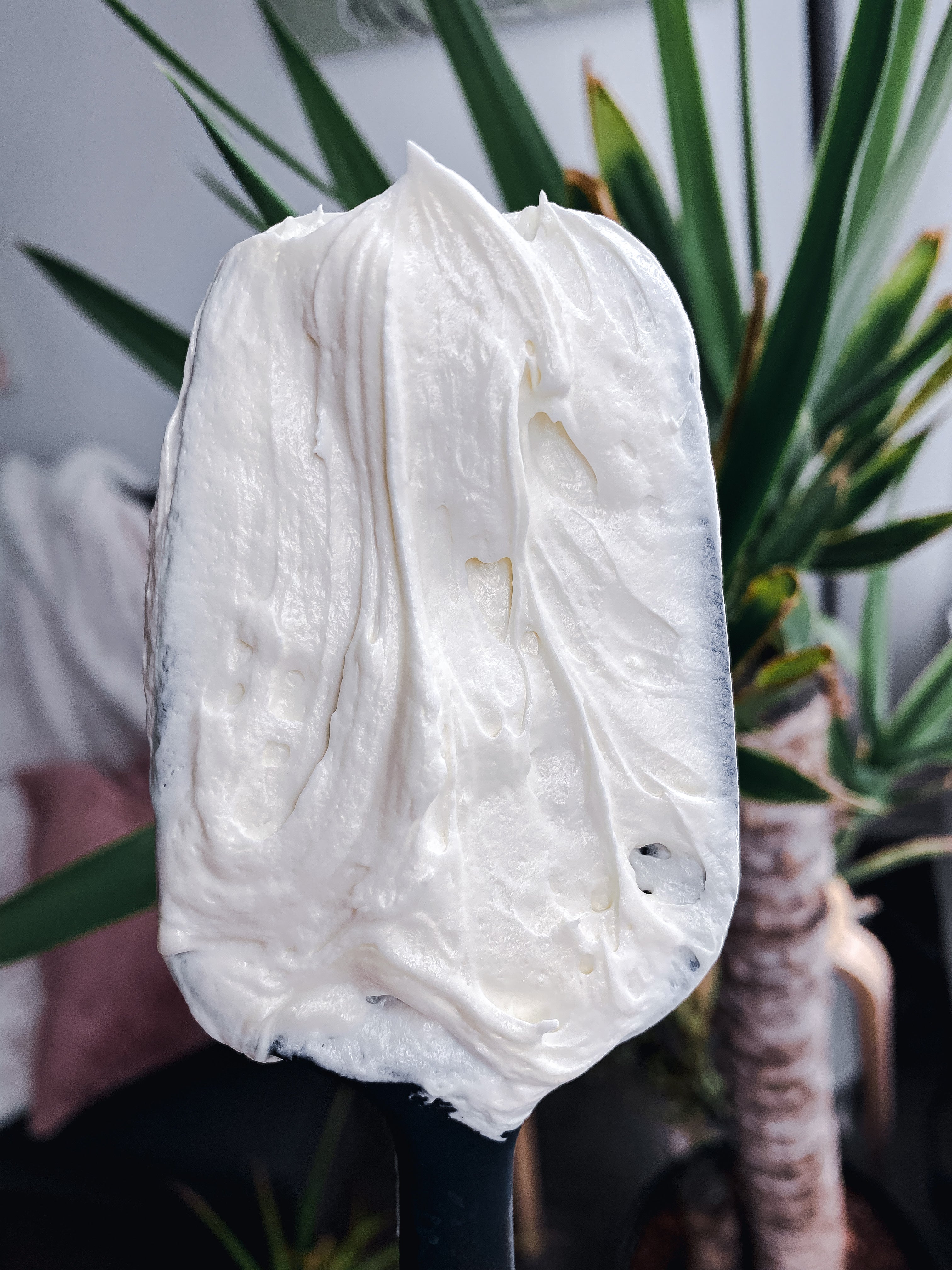 nuska.ca body butter in a spatula showing the creamy texture of the butter